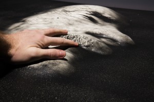 A hand touching an image that has been translated into a tactile and audio described version.